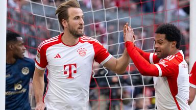 Harry Kane celebrates scoring his hat-trick for Bayern Munich
