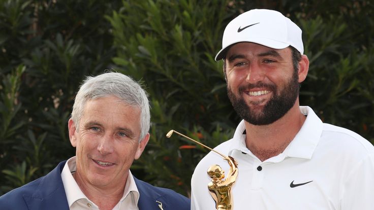 PONTE VEDRA BEACH, FL - MARCH 17: PGA golfer Scottie Scheffler poses with the trophy and commissioner Jay Monahan after winning The Players Championship on March 17, 2024, at TPC Sawgrass in Ponte Vedra Beach, Florida. (Photo by Brian Spurlock/Icon Sportswire) (Icon Sportswire via AP Images)