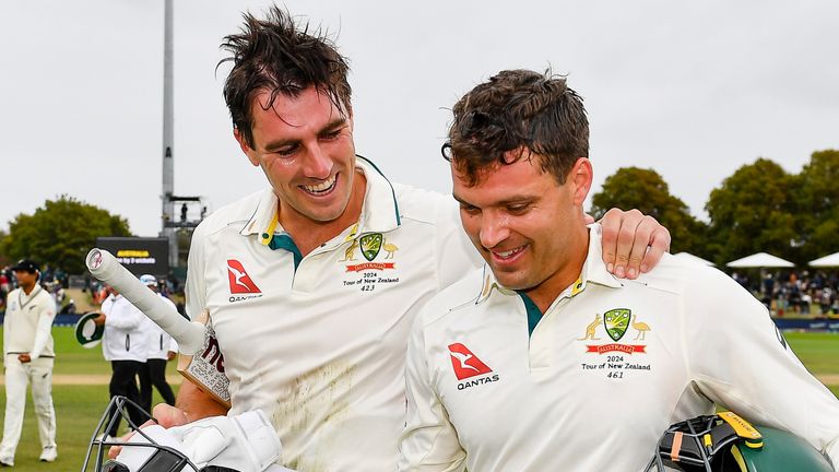 Australia's Alex Carey, right, and Pat Cummins celebrate as the leave the field after defeating New Zealand by three wickets 