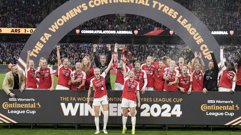 Arsenal's Leah Williamson (centre left) and Kim Little lift the Conti Cup after defeating Chelsea