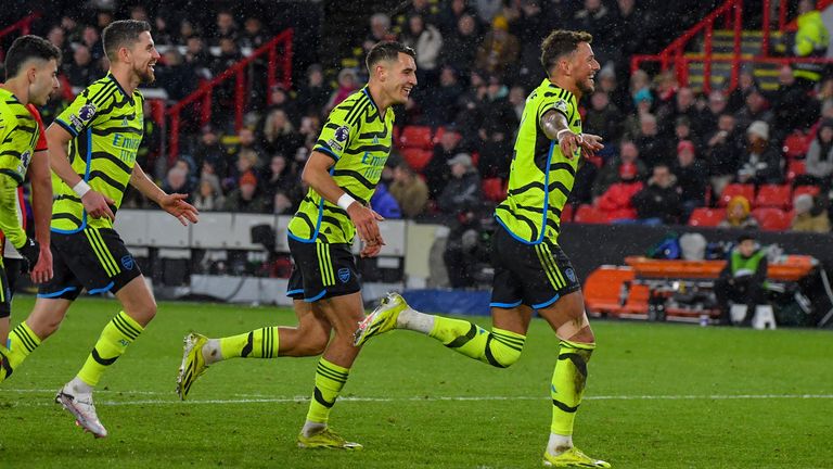 Arsenal's Ben White celebrates with teammates after scoring his side's sixth goal during the English Premier League soccer match between Sheffield United and Arsenal at the Bramall Lane stadium in Sheffield, England, Monday, March 4, 2024. (AP Photo/Rui Vieira)