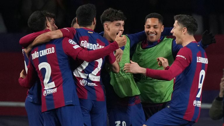 Barcelona's Robert Lewandowski, right, celebrates with his teammates after scoring his side's third goal against Napoli in the Champions League last-16