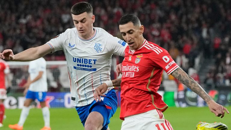 Benfica's Angel Di Maria, right, strikes the ball challenged by Rangers' Tom Lawrence 