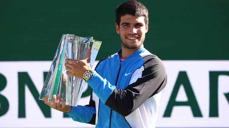 Carlos Alcaraz of Spain holds his winners trophy after his straight sets victory against Daniil Medvedev in the Men's Final during the BNP Paribas Open at Indian Wells Tennis Garden on March 17, 2024 in Indian Wells, California. (Photo by Clive Brunskill/Getty Images)