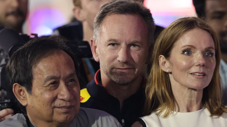 Christian Horner watches the Bahrain GP podium ceremony with Red Bull owner Chalerm Yoovidhya (L) and his wife Geri Haliwell-Horner (R)