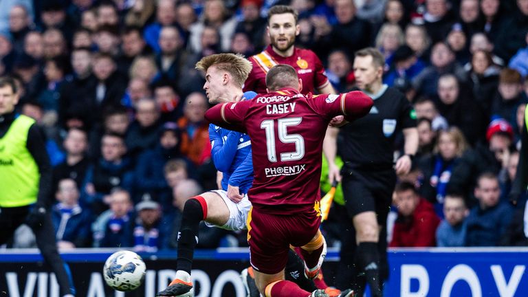 GLASGOW, SCOTLAND - MARCH 02: Motherwell's Dan Casey tackles Rangers' Ross McCausland during a cinch Premiership match between Rangers and Motherwell at Ibrox Stadium, on March 02, 2024, in Glasgow, Scotland. (Photo by Craig Foy / SNS Group)
