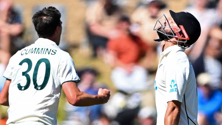 New Zealand's Daryl Mitchell, right, throws his head back after being caught out from the bowling of Australia's Pat Cummins, left, on the second day of their cricket test match in Wellington, New Zealand, Friday March 1, 2024. (Kerry Marshall/Photosport via AP)