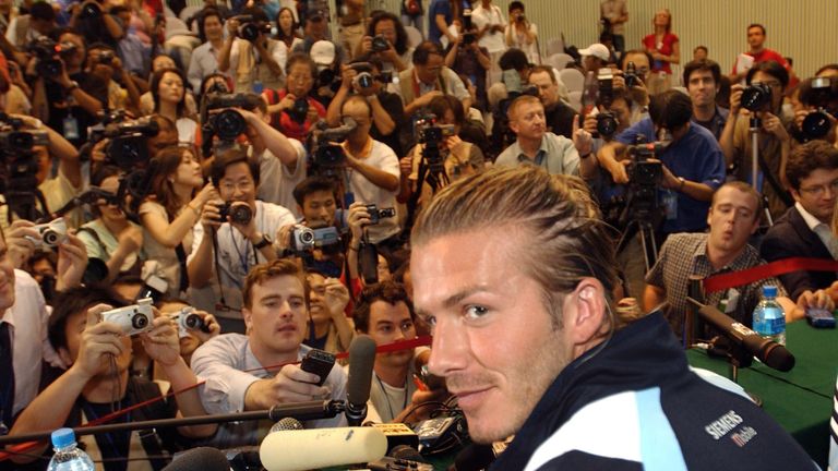 Real Madrid's David Beckham, center, arrives at a news conference after a training session at the Hongta Sport complex in Kunming, southern China, Wednesday, July 30, 2003. Real Madrid is in China as part of an exhibition soccer tour including Japan and Hong Kong.