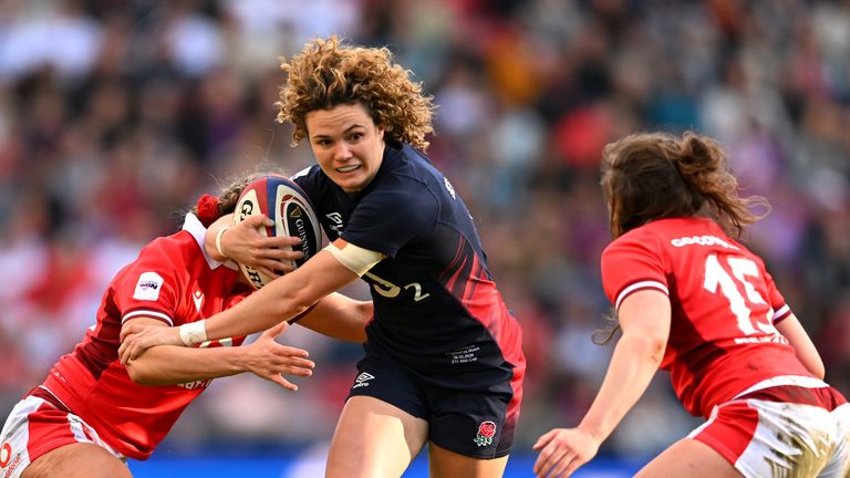 Elie Koldon is treated from England by Hannah Jones and Jenny Heeskith from Wales during the six nations of women