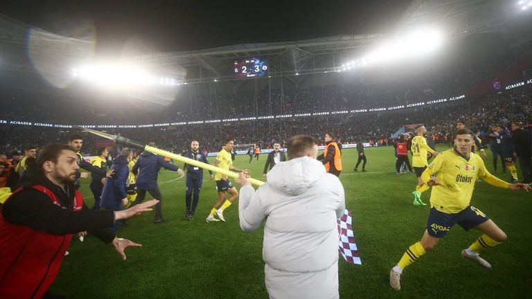 Trabzonspor fans invade the pitch after Fenerbahce's win