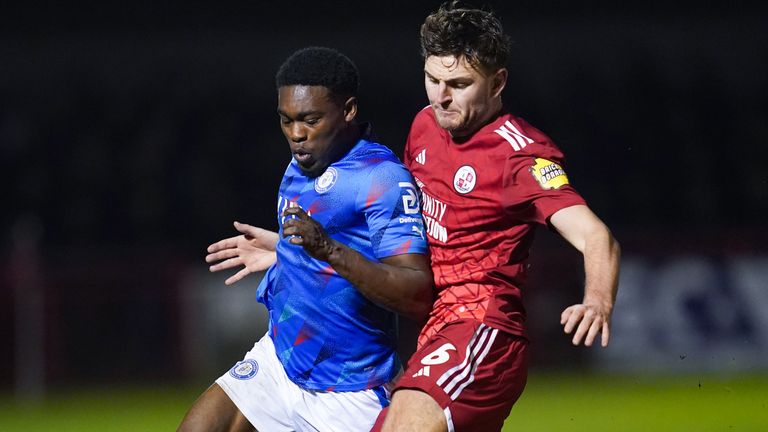 Stockport County's Isaac Olaofe and Crawley Town's Laurence Maguire 