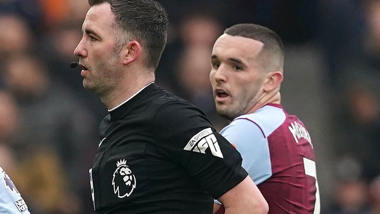 John McGinn looks to referee Chris Kavanagh after being shown a red card