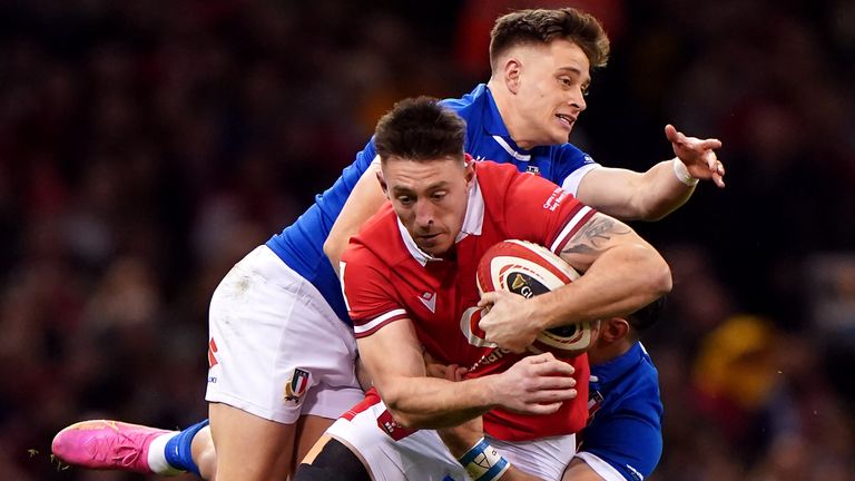 Wales' Josh Adams is tackled by Italy's Stephen Varney and Tommaso Menoncello (PA Images)