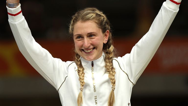 Gold medal winner Laura Kenny of England celebrates on the podium after the women's 10km scratch race final during the Commonwealth Games track cycling at Lee Valley VeloPark in London, Monday, Aug. 1, 2022. (AP Photo/Ian Walton)