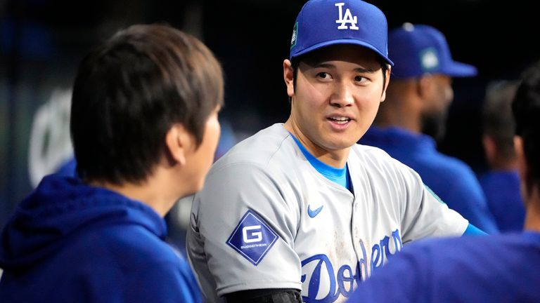 Los Angeles Dodgers designated hitter Shohei Ohtani, right, talks with interpreter Ippei Mizuhara during the ninth inning of an opening day baseball game against the San Diego Padres at the Gocheok Sky Dome in Seoul, South Korea Wednesday, March 20, 2024, in Seoul, South Korea. (AP Photo/Lee Jin-man)