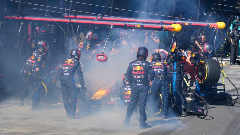 Mechanics work to extinguish a fire in Red Bull driver Max Verstappen of the Netherlands&#39; car during the Australian Formula One Grand Prix at Albert Park, in Melbourne, Australia, Sunday, March 24, 2024.