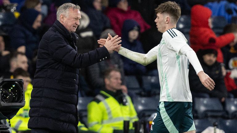 Northern Ireland's Conor Bradley shakes hands with head coach Michael O'Neill