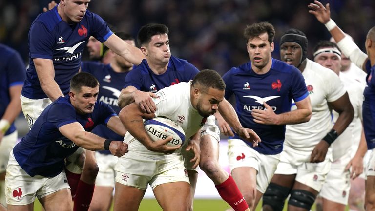 England's Ollie Lawrence (centre) is tackled by France's Thomas Ramos (left) during the Guinness Six Nations match at the Groupama Stadium in Lyon, France. Picture date: Saturday March 16, 2024.