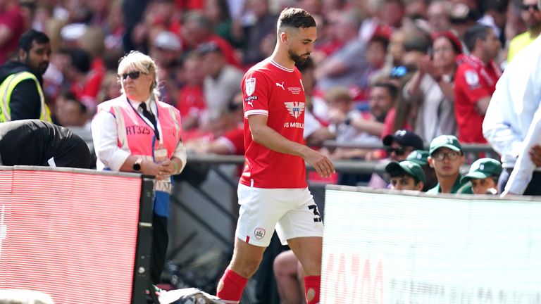Barnsley's Adam Phillips walks off the pitch after being sent off for serious foul play during the Sky Bet League One play-off final.