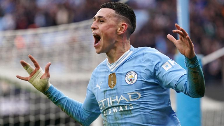 Phil Foden celebrates after scoring his second goal in the Manchester derby