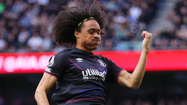Tahith Chong leaps in celebration after giving Luton an early leat Spurs