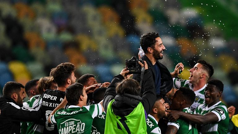 Players toss Sporting's head coach Ruben Amorim after winning the Portuguese League football match against Boavista and the Portuguese League title at the Jose Alvalade stadium in Lisbon on May 11, 2021.