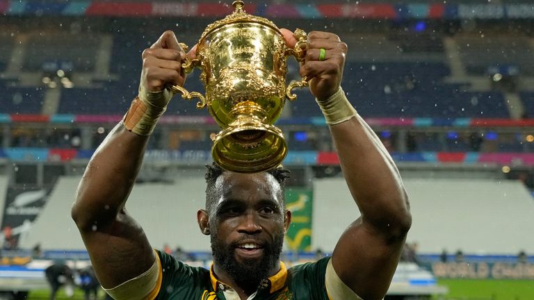 South Africa's Siya Kolisi holds the trophy aloft as he celebrates after the Rugby World Cup final match between New Zealand and South Africa 