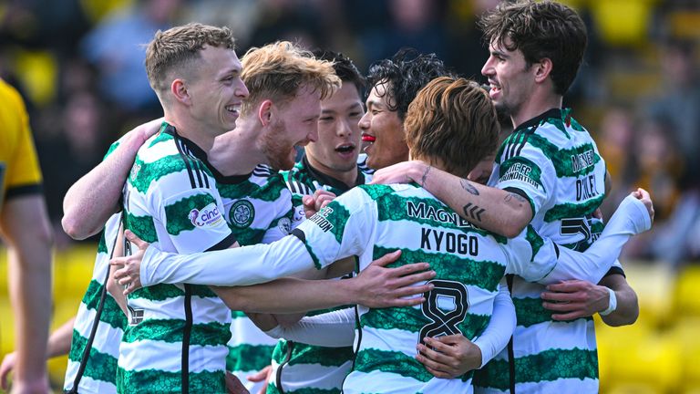 Celtic players celebrate after taking the lead at Livingston through a Jamie Brandon own goal
