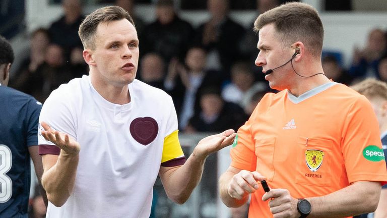 DINGWALL, SCOTLAND - MARCH 16: Hearts' Lawrence Shankland is booked by referee Grant Irvine for a dive in the box during a cinch Premiership match between Ross County and Heart of Midlothian at the Global Energy Stadium, on March 16, 2024, in Dingwall, Scotland. (Photo by Ross Parker / SNS Group)