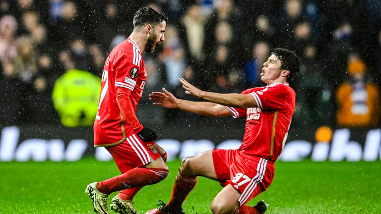 GLASGOW, SCOTLAND - MARCH 14: Benfica's Rafa Silva (left) celebrates with Joao Neves after scoring to make it 1-0 during a UEFA Europa League Round of 16 second leg match between Rangers and Benfica at Ibrox Stadium, on March 14, 2024, in Glasgow, Scotland. (Photo by Rob Casey / SNS Group)