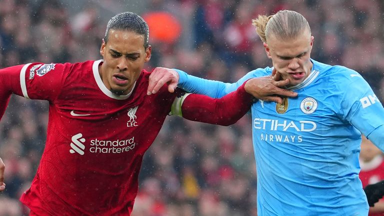 Liverpool's Virgil van Dijk challenges Manchester City's Erling Haaland as he attempts to shoot