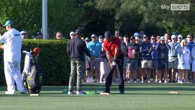 Charlie Woods helps dad Tiger on the range at The Masters
