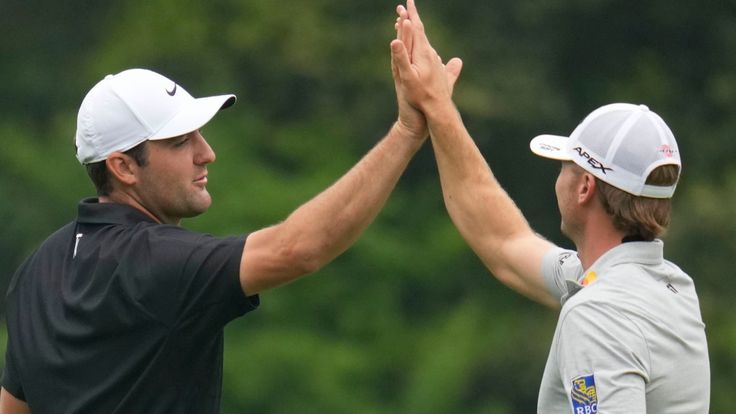 Sam Burns and Scottie Scheffler react on the 11th green during a practice for the Masters golf tournament at Augusta National Golf Club, Tuesday, April 4, 2023, in Augusta, Ga. (AP Photo/Mark Baker)