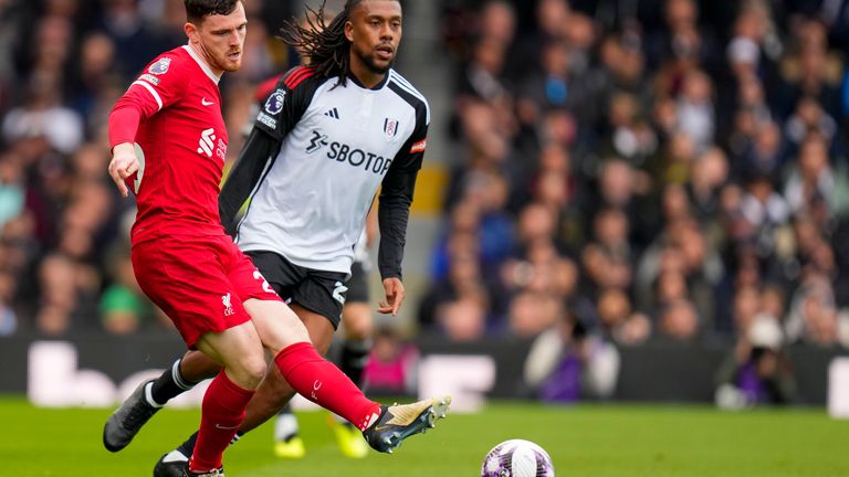 Andrew Robertson and Alex Iwobi in Premier League action at Craven Cottage