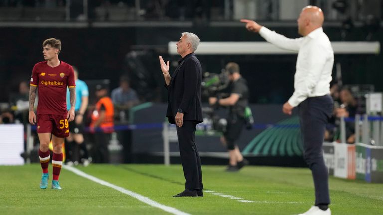 Roma's head coach Jose Mourinho, center, and Feyenoord's head coach Ame Slot, right, give instructions from the side line during the Europa Conference League final soccer match between AS Roma and Feyenoord at National Arena in Tirana, Albania, Wednesday, May 25, 2022.