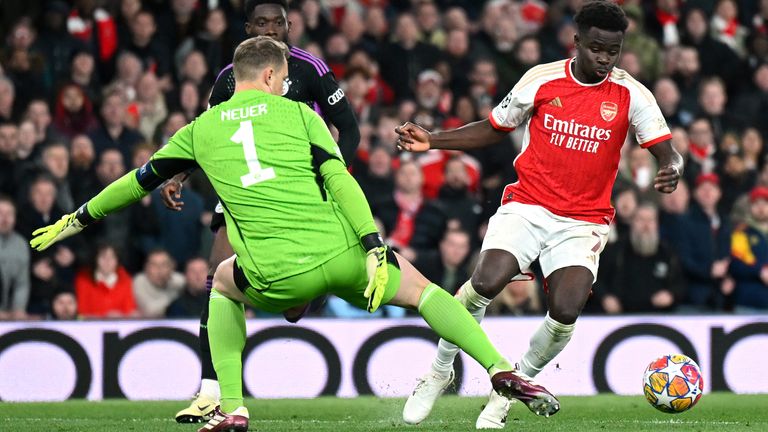 LONDON, ENGLAND - APRIL 09: Bukayo Saka of Arsenal is tackled by Manuel Neuer of Bayern Munich during the UEFA Champions League quarter-final first leg match between Arsenal FC and FC Bayern München at Emirates Stadium on April 09, 2024 in London, England. (Photo by Shaun Botterill/Getty Images)