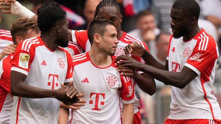 Raphael Guerreiro is congratulated after opening the scoring for Bayern Munich against Cologne