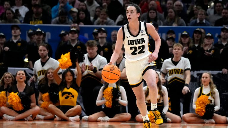 Iowa guard Caitlin Clark (22) drives up court during the first half of a Final Four college basketball game against UConn in the women's NCAA Tournament, Friday, April 5, 2024, in Cleveland. (AP Photo/Carolyn Kaster)