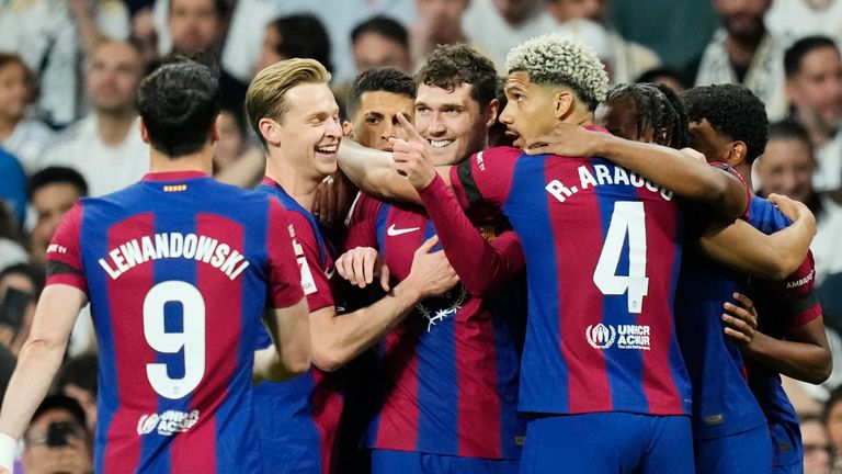Barcelona's team players celebrate after Andreas Christensen, centre, scored the opening goal during the Spanish La Liga soccer match between Real Madrid and Barcelona at the Santiago Bernabeu stadium in Madrid, Spain, Sunday, April 21, 2024. (AP Photo/Jose Breton)