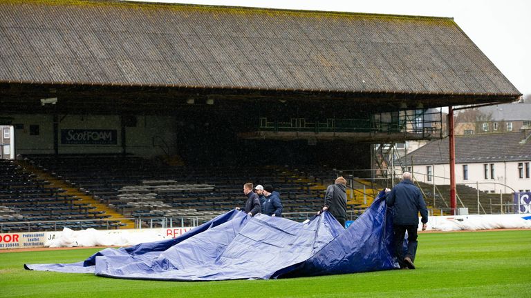 DUNDEE, SCOTLAND - APRIL 10: Dundee groundsmen relay the pitch cover during a pitch inspection ahead of a cinch Premiership match between Dundee and Rangers at the Scot Foam Stadium at Dens Park, on April 10, 2024, in Dundee, Scotland. (Photo by Ewan Bootman / SNS Group)