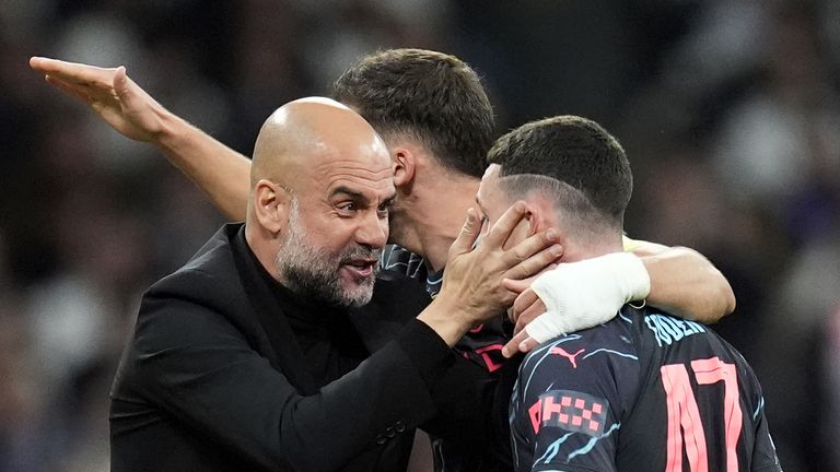 Manchester City's Phil Foden celebrates scoring his sides second goal with manager Pep Guardiola during the UEFA Champions League quarter-final, first leg match at the Santiago Bernabeu Stadium, Madrid. Picture date: Tuesday April 9, 2024.
