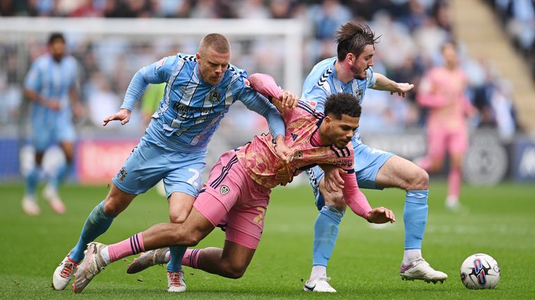 Georginio Rutter of Leeds United battles for possession with Jake Bidwell and Liam Kitching of Coventry City