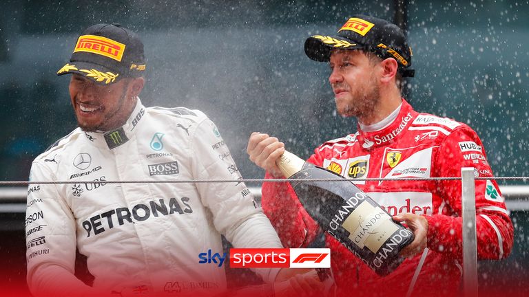 Mercedes driver Lewis Hamilton of Britain, left, is sprayed champaign by Ferrari driver Sebastian Vettel of Germany on the podium after winning the Chinese Formula One Grand Prix at the Shanghai International Circuit in Shanghai, China, Sunday, April 9, 2017. Vettel finished second.