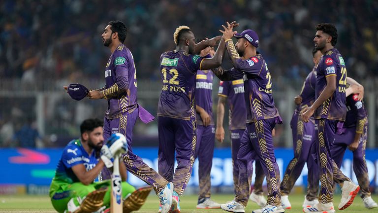 Royal Challengers Bengaluru&#39;s Mohammed Siraj sits dejected as Kolkata Knight Riders&#39; players celebrate their team&#39;s win over Royal Challengers Bengaluru in the Indian Premier League cricket match in Kolkata, India, Sunday, April 21, 2024. (AP Photo/Bikas Das)


