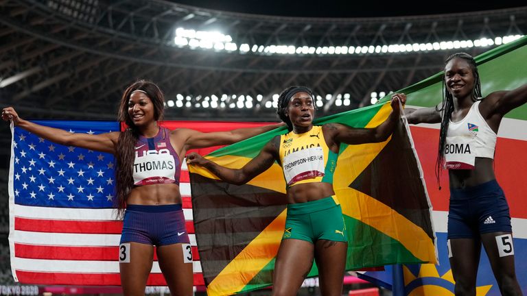 Gold medallist Elaine Thompson-Herah, centre, with silver medallist Christine Mboma and bronze medallist Thomas after the final of the women's 200m at the 2020 Summer Olympics