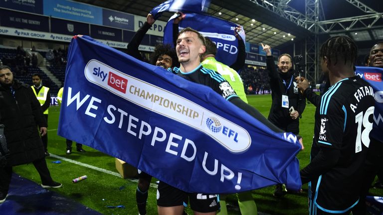 Leicester midfielder Kiernan Dewsbury-Hall holds up a 'We Stepped Up' banner on the pitch