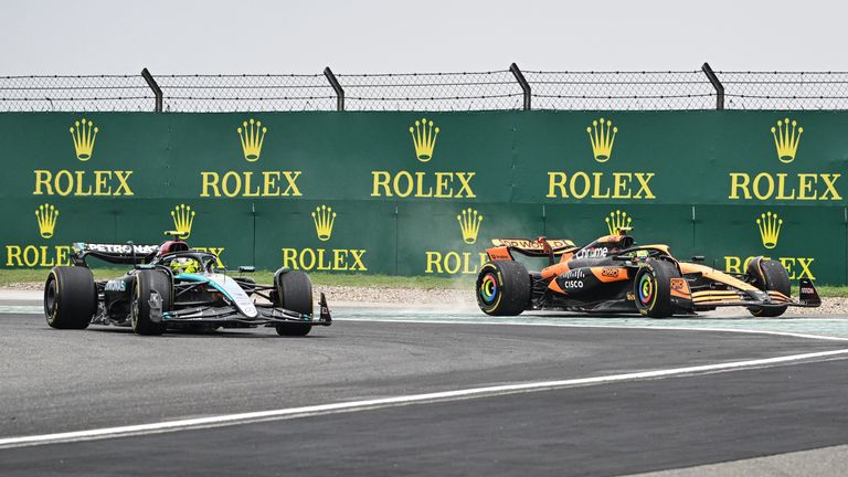 Mercedes' British driver Lewis Hamilton (L) and McLaren's British driver Lando Norris (R)  fight for the lead at the second corner of the first lap during the sprint race ahead of the Formula One Chinese Grand Prix at the Shanghai International Circuit in Shanghai on April 20, 2024. (Photo by Hector RETAMAL / AFP)