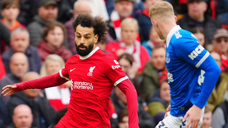 Liverpool's Mohamed Salah, left, challenges for the ball with Everton's Jarrad Branthwaite at Anfield