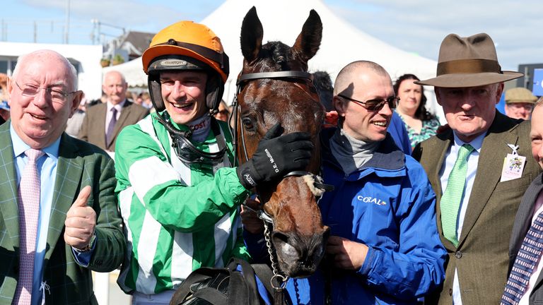 Willie Mullins and Danny Mullins celebrate with Macdermott following the win in the Scottish Grand National