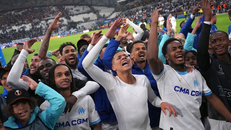 Marseille players celebrate after winning a penalty shootout against Benfica